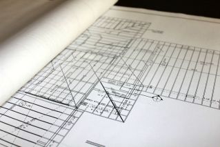 Man in Plaid Shirt Wearing Hard Hat while Looking at Camera